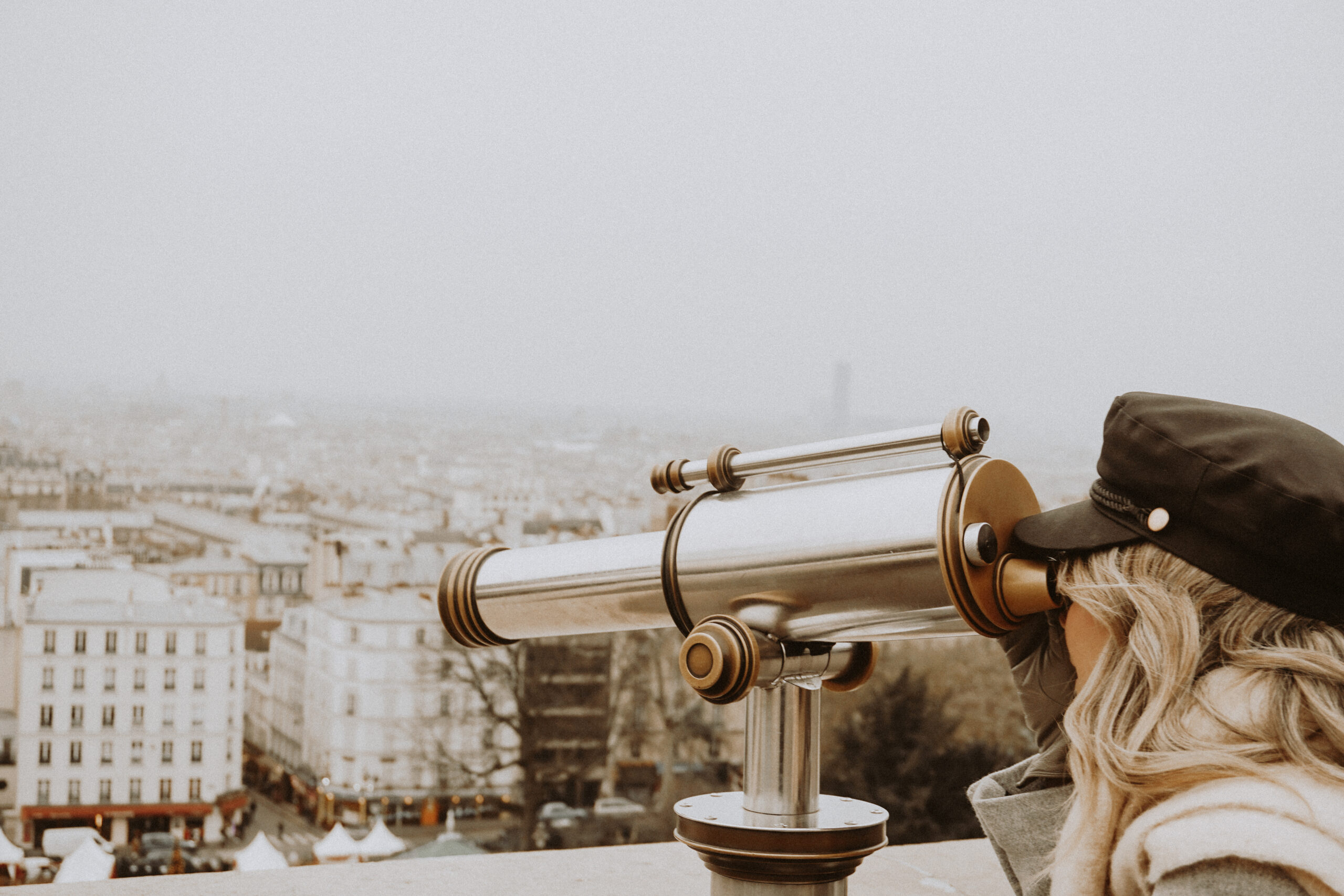 woman looking through scope in paris