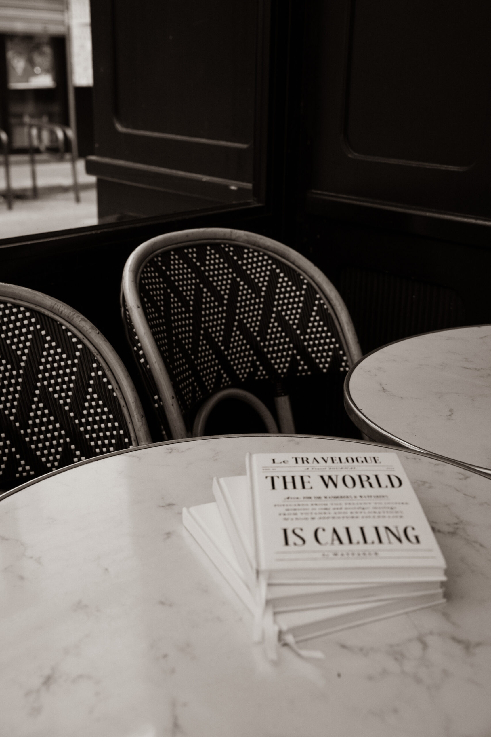 Travel Notebook and Linen Journal on Cafe Table in Paris