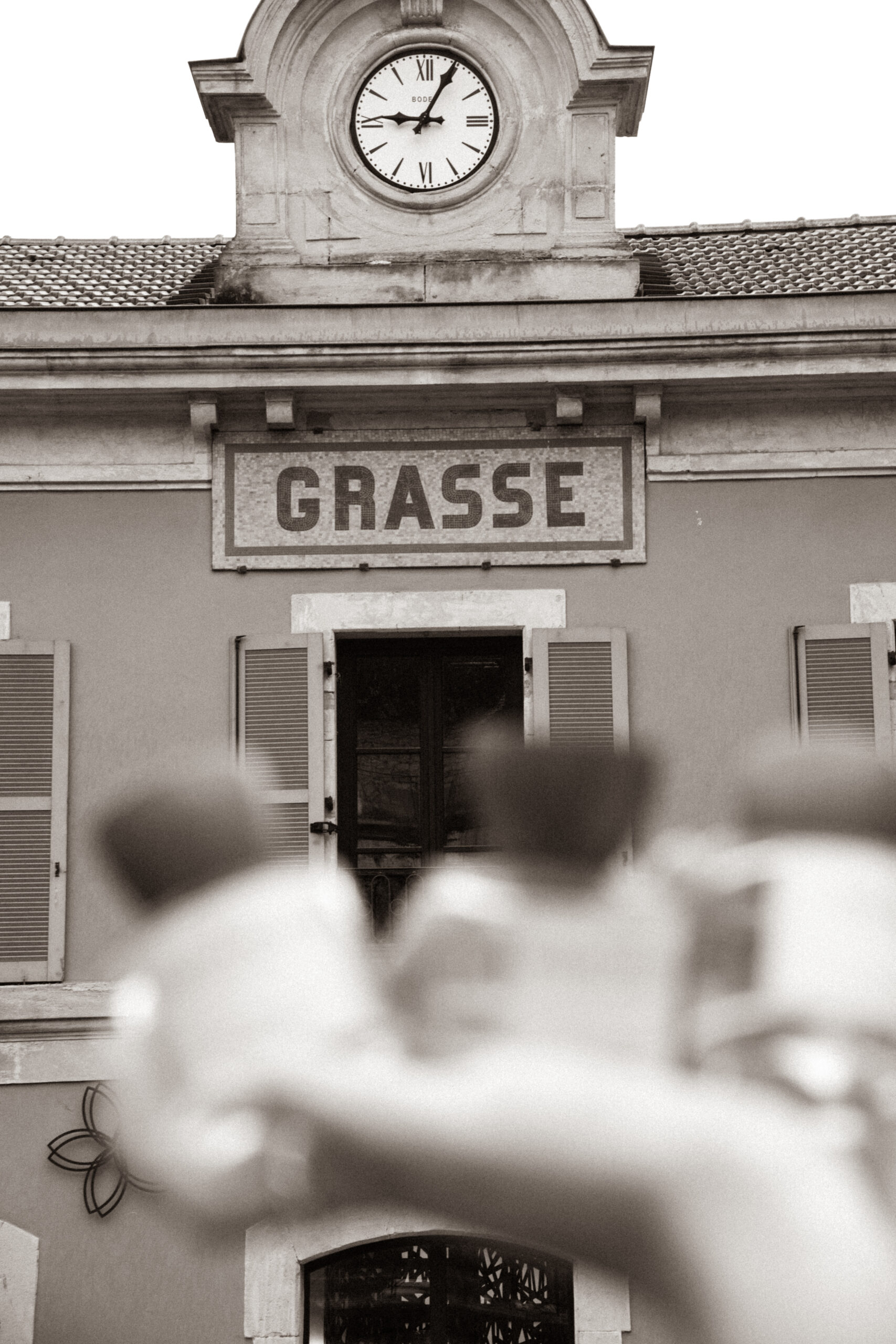 perfume in front of sign in grasse france